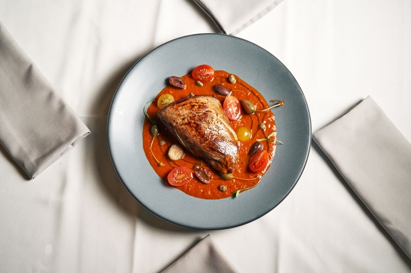 Grilled chicken breast with herbs and roasted vegetables